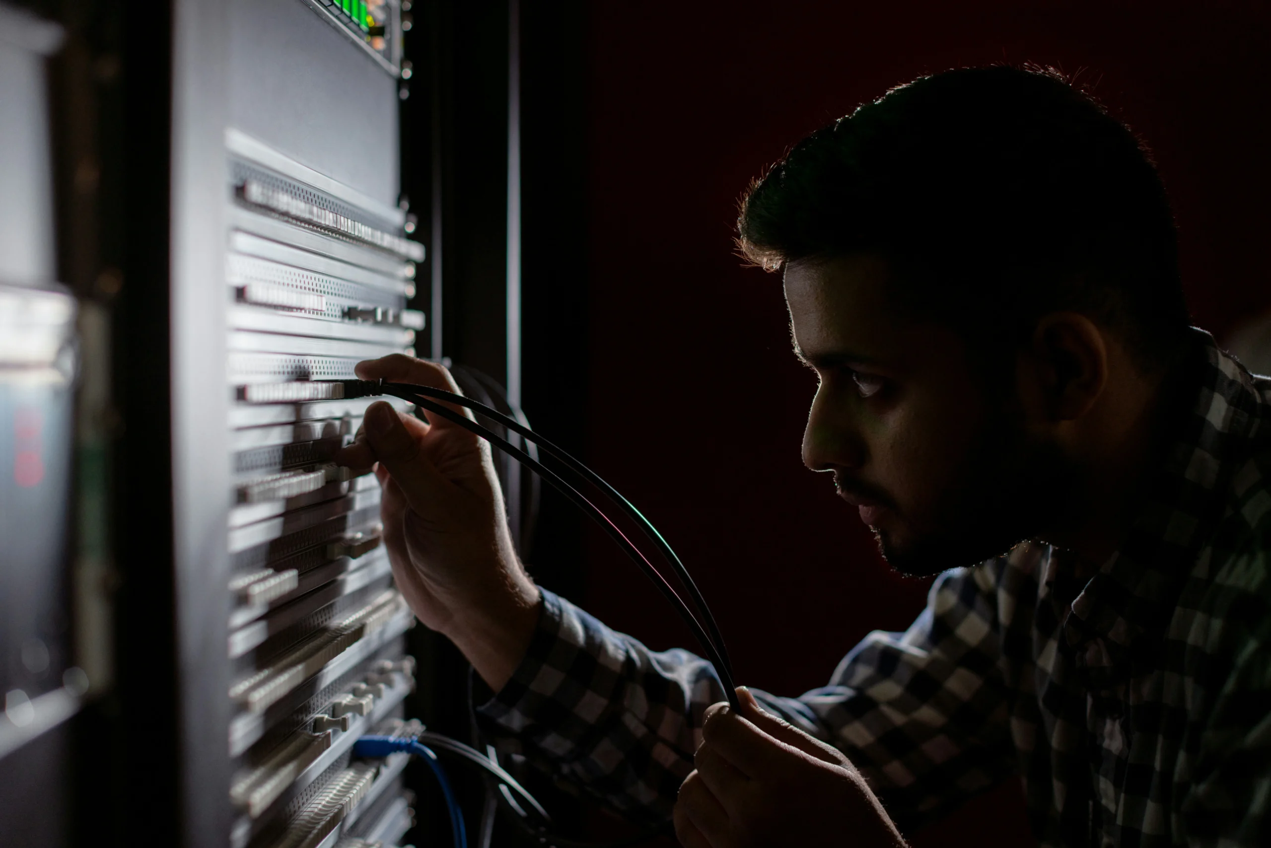 Chicago Network Solutions technician terminating structured cabling inside a commercial network rack